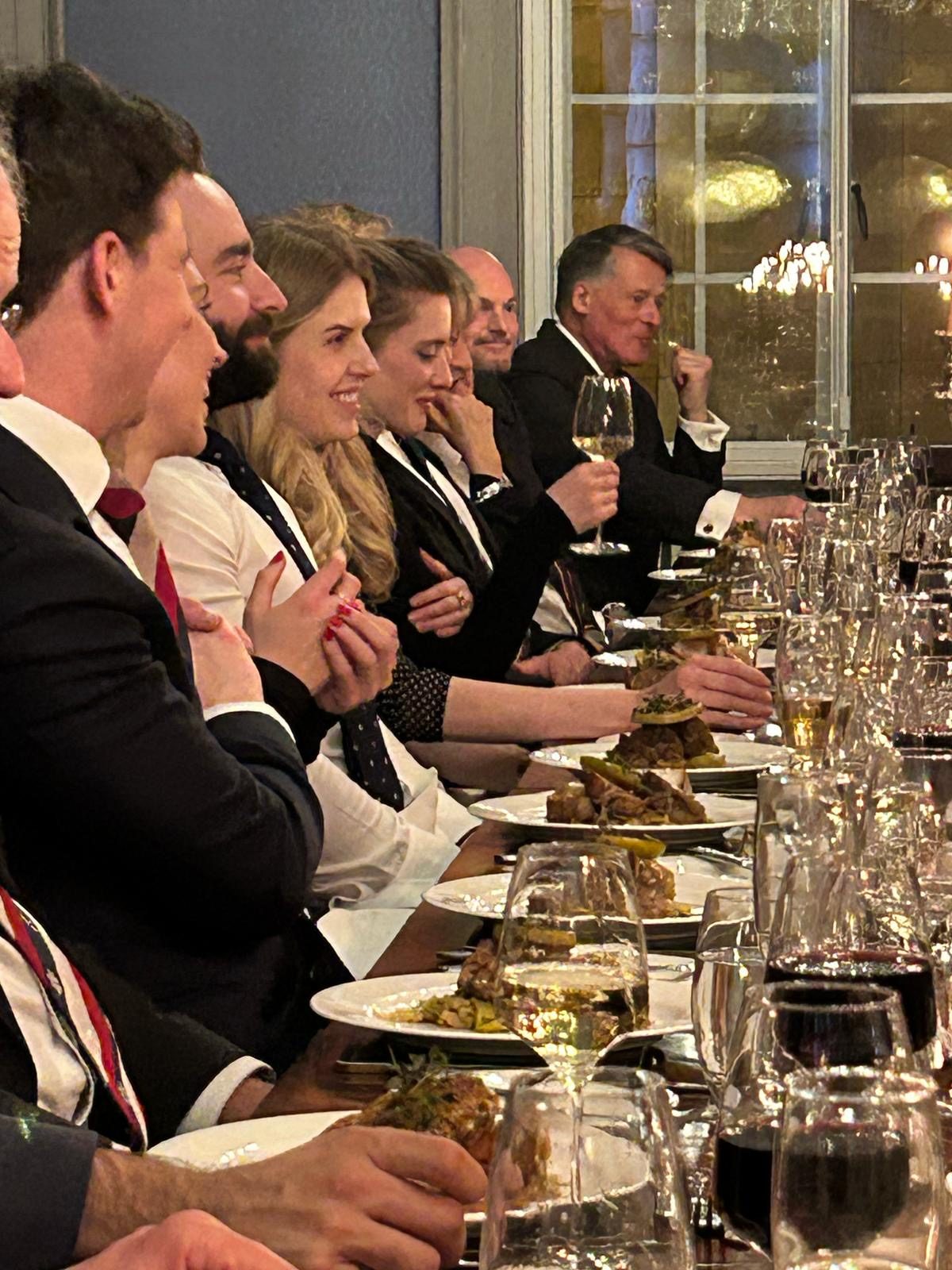 Members and guests laughing together at the dinner table
